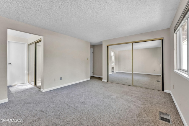 1425 Julie Ct, Reno, NV 89509 - unfurnished bedroom with carpet, a textured ceiling, and two closets