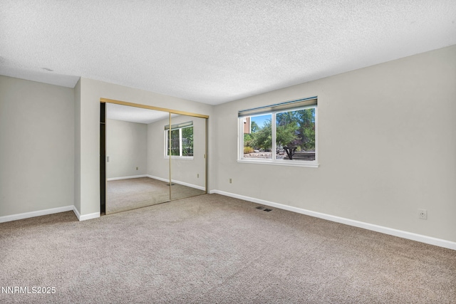 1425 Julie Ct, Reno, NV 89509 - unfurnished bedroom featuring carpet floors, a textured ceiling, and a closet