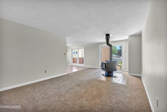 1425 Julie Ct, Reno, NV 89509 - unfurnished living room with a wood stove, carpet flooring, and a textured ceiling
