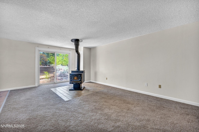 1425 Julie Ct, Reno, NV 89509 - unfurnished living room featuring a wood stove, carpet, and a textured ceiling