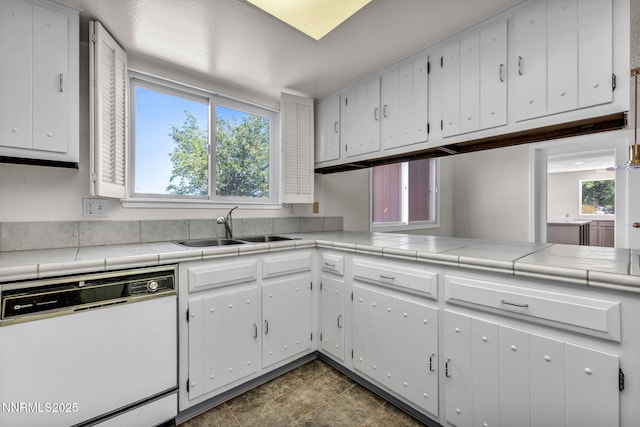 1425 Julie Ct, Reno, NV 89509 - kitchen with dishwasher, healthy amount of natural light, and white cabinets