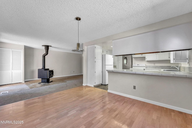 1425 Julie Ct, Reno, NV 89509 - kitchen with freestanding refrigerator, tile countertops, electric range oven, exhaust hood, and a textured ceiling