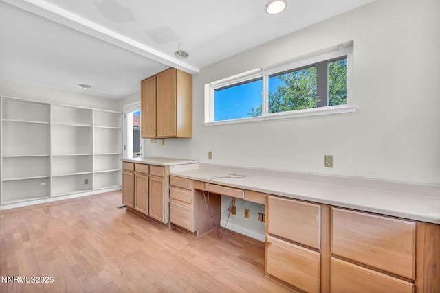 1425 Julie Ct, Reno, NV 89509 - kitchen with built in desk, light wood-style flooring, and light countertops