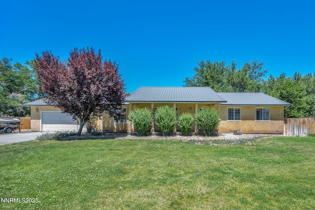 4210 Magnolia Rd, Fallon, NV 89406 - view of front facade featuring stucco siding, driveway, a metal roof, and an attached garage
