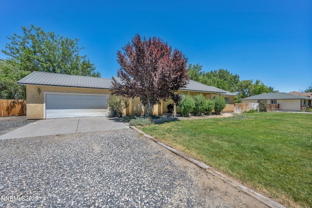 4210 Magnolia Rd, Fallon, NV 89406 - view of front of home with concrete driveway, an attached garage, stucco siding, and a metal roof