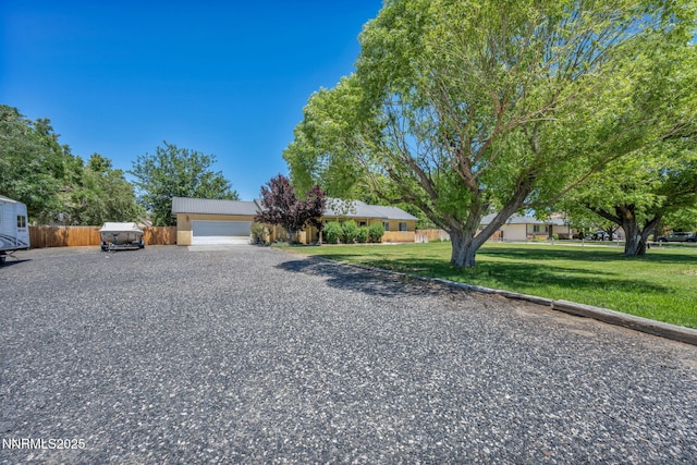 4210 Magnolia Rd, Fallon, NV 89406 - view of front of property featuring gravel driveway, an attached garage, and stucco siding