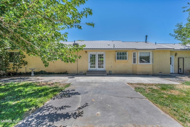 4210 Magnolia Rd, Fallon, NV 89406 - rear view of house with stucco siding, entry steps, and a metal roof