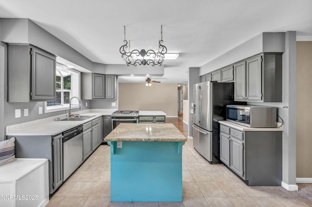 4210 Magnolia Rd, Fallon, NV 89406 - kitchen featuring appliances with stainless steel finishes, gray cabinetry, a center island, light countertops, and a ceiling fan