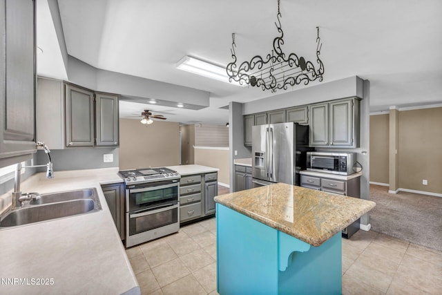 4210 Magnolia Rd, Fallon, NV 89406 - kitchen with appliances with stainless steel finishes, gray cabinets, light countertops, a center island, and ceiling fan