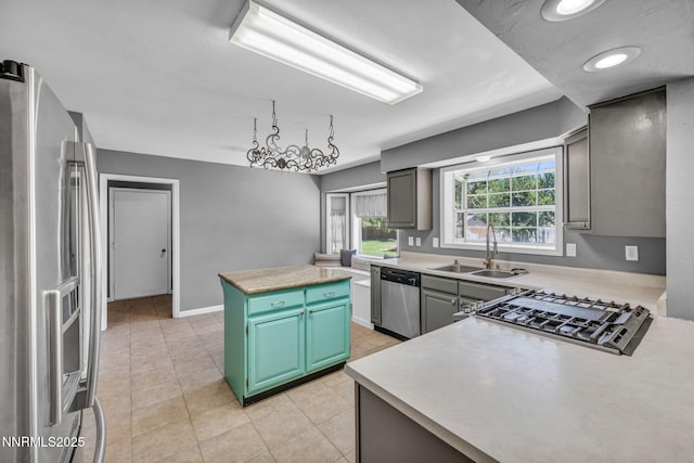 4210 Magnolia Rd, Fallon, NV 89406 - kitchen with appliances with stainless steel finishes, a kitchen island, light countertops, and light tile patterned floors