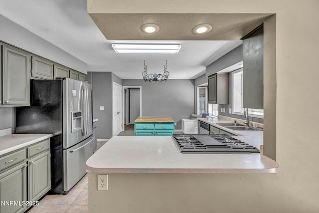 4210 Magnolia Rd, Fallon, NV 89406 - kitchen with appliances with stainless steel finishes, light countertops, a peninsula, and light tile patterned flooring