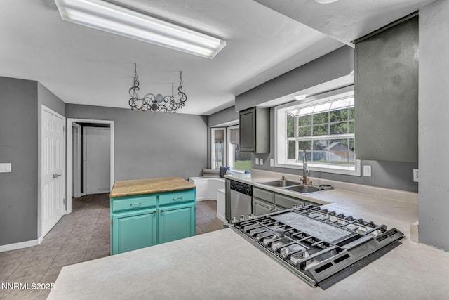 4210 Magnolia Rd, Fallon, NV 89406 - kitchen with dishwasher, stovetop, light countertops, and light tile patterned flooring
