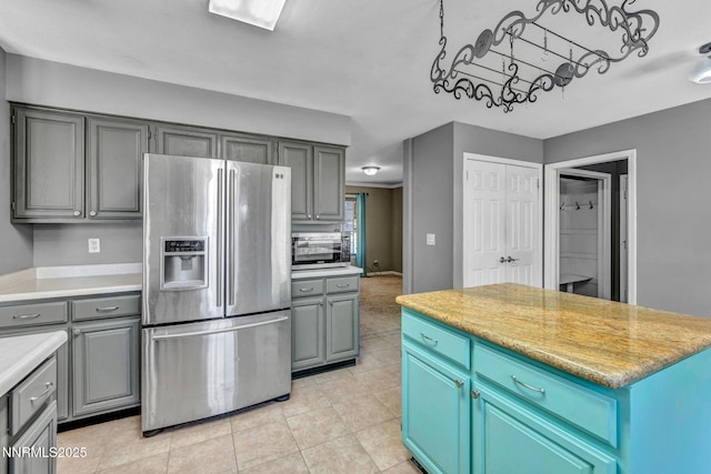 4210 Magnolia Rd, Fallon, NV 89406 - kitchen with stainless steel appliances, gray cabinetry, light countertops, and light tile patterned flooring