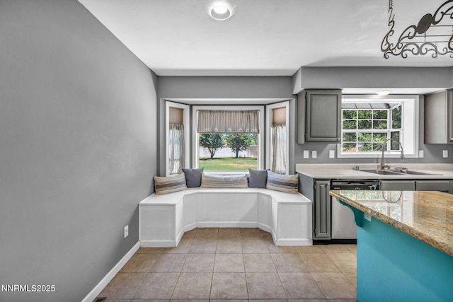 4210 Magnolia Rd, Fallon, NV 89406 - kitchen with dishwasher, light tile patterned floors, and gray cabinets