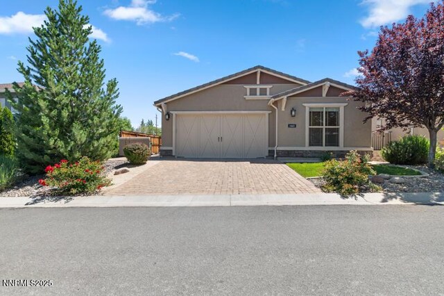 1460 Waterloo Dr, Reno, NV 89509 - view of front of house with a garage, decorative driveway, and stucco siding