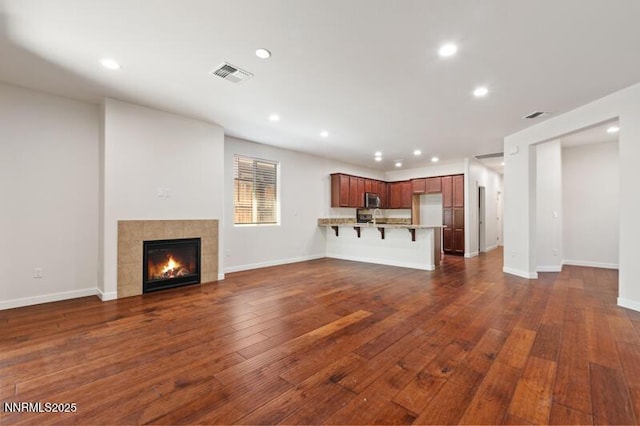 1460 Waterloo Dr, Reno, NV 89509 - unfurnished living room with recessed lighting, dark wood-style floors, and a fireplace