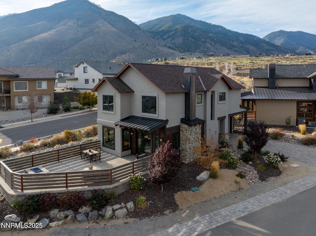 2912 Portrush Dr, Genoa, NV 89411 - view of front of property featuring a standing seam roof, stucco siding, a chimney, a shingled roof, and a metal roof