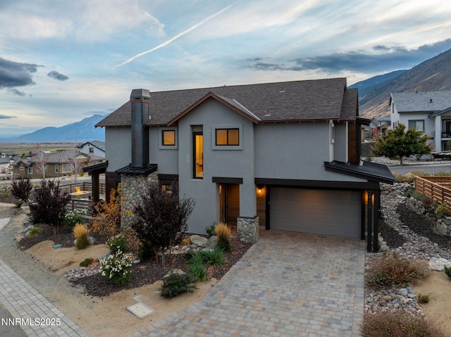 2912 Portrush Dr, Genoa, NV 89411 - modern home with a mountain view, a garage, stone siding, stucco siding, and decorative driveway