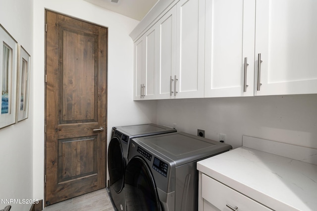 2912 Portrush Dr, Genoa, NV 89411 - laundry room featuring cabinet space, washer and dryer, and light wood finished floors