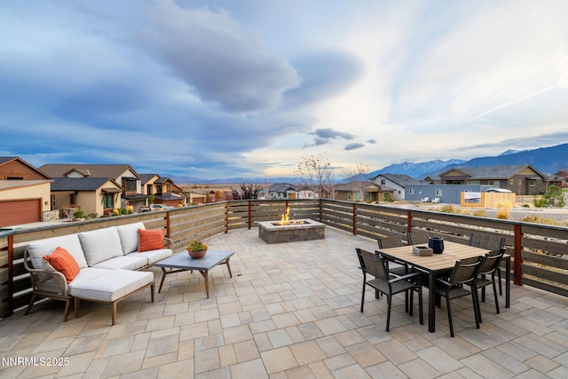 2912 Portrush Dr, Genoa, NV 89411 - view of patio with a residential view, an outdoor living space with a fire pit, outdoor dining area, and a mountain view