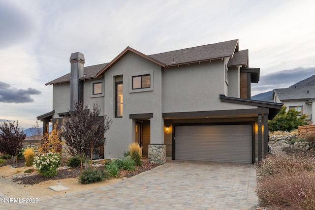 2912 Portrush Dr, Genoa, NV 89411 - view of front of home featuring stucco siding, an attached garage, and decorative driveway