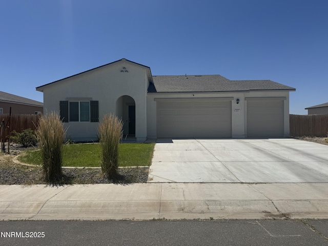 427 Agate Ln, Fallon, NV 89406 - view of front facade with a garage, stucco siding, and driveway