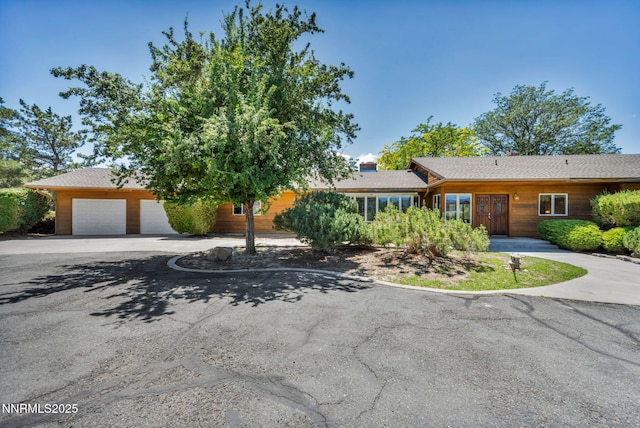 1405 Primrose Ln, Minden, NV 89423 - view of front of home with driveway and a garage