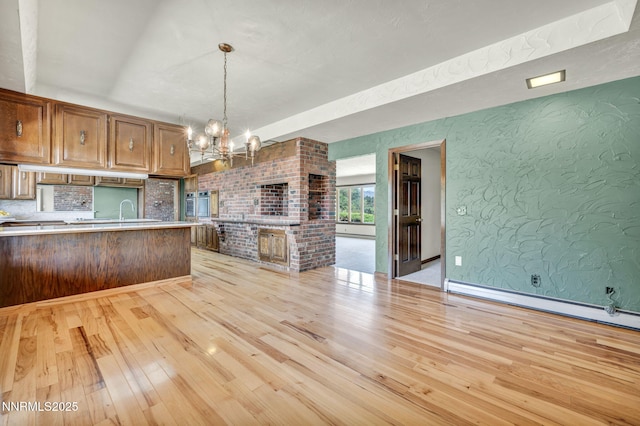 1405 Primrose Ln, Minden, NV 89423 - kitchen featuring light wood-style floors, a chandelier, light countertops, open floor plan, and stainless steel oven