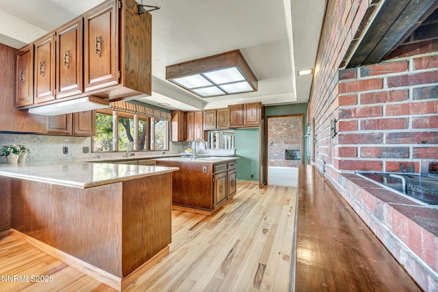 1405 Primrose Ln, Minden, NV 89423 - kitchen featuring light wood-style floors, brown cabinets, and a peninsula
