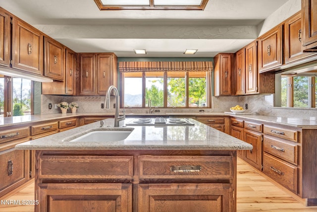 1405 Primrose Ln, Minden, NV 89423 - kitchen featuring stovetop with downdraft, healthy amount of natural light, and light wood-style floors