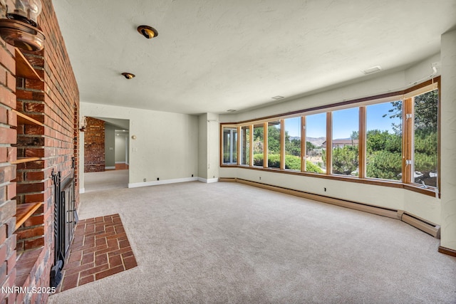 1405 Primrose Ln, Minden, NV 89423 - unfurnished living room with carpet floors, a baseboard radiator, a fireplace, and a textured ceiling