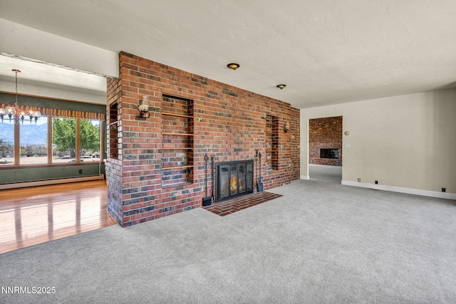 1405 Primrose Ln, Minden, NV 89423 - unfurnished living room featuring a brick fireplace, baseboard heating, carpet flooring, and a chandelier
