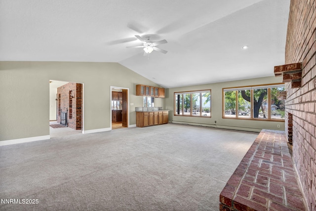 1405 Primrose Ln, Minden, NV 89423 - unfurnished living room with a fireplace, ceiling fan, baseboard heating, vaulted ceiling, and light carpet