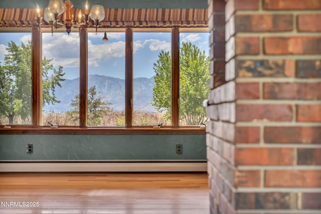 1405 Primrose Ln, Minden, NV 89423 - unfurnished sunroom featuring plenty of natural light, a chandelier, a baseboard heating unit, and a mountain view