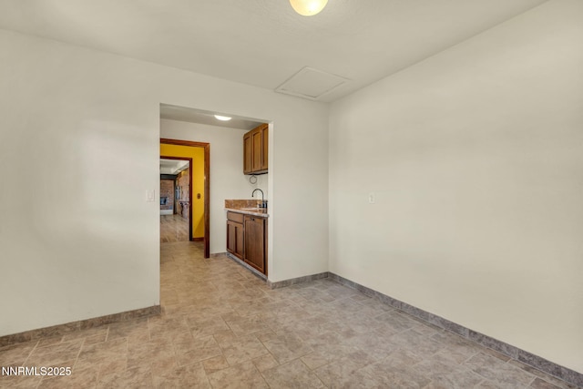 1405 Primrose Ln, Minden, NV 89423 - spare room featuring stone finish floors and attic access