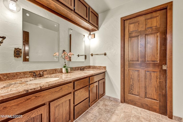 1405 Primrose Ln, Minden, NV 89423 - full bath featuring double vanity, a textured wall, and stone finish flooring