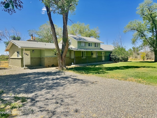7650 Grass Valley Rd, Winnemucca, NV 89445 - view of front of home with driveway, a front lawn, and a chimney