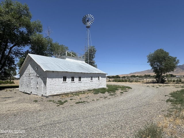 7650 Grass Valley Rd, Winnemucca, NV 89445 - view of property exterior with an outbuilding and a mountain view