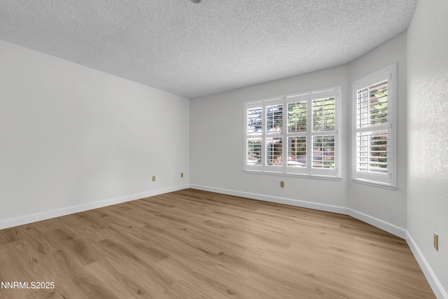 2875 Idlewild Dr Apt 5, Reno, NV 89509 - empty room featuring light wood finished floors, a textured ceiling, and healthy amount of natural light