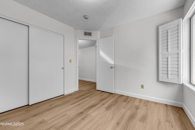 2875 Idlewild Dr Apt 5, Reno, NV 89509 - unfurnished bedroom with a textured ceiling, wood finished floors, and a closet