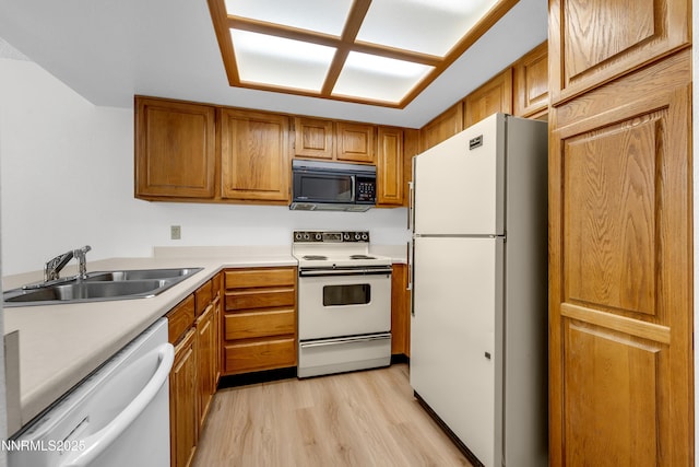 2875 Idlewild Dr Apt 5, Reno, NV 89509 - kitchen with white appliances, brown cabinets, light wood-type flooring, and light countertops