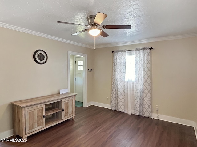 540 Garrison St, Winnemucca, NV 89445 - spare room featuring dark wood-style floors, plenty of natural light, ceiling fan, and crown molding