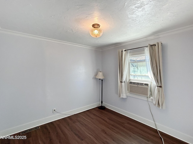 540 Garrison St, Winnemucca, NV 89445 - empty room with dark wood-type flooring, cooling unit, and crown molding