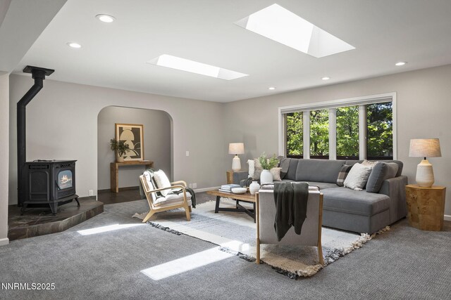 1705 Blue Spruce Rd, Reno, NV 89511 - carpeted living room with a skylight, a wood stove, recessed lighting, and arched walkways