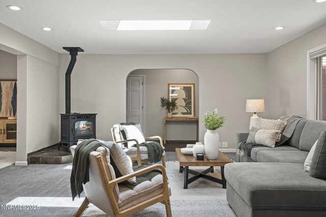 1705 Blue Spruce Rd, Reno, NV 89511 - living area with a wood stove, recessed lighting, a skylight, light carpet, and arched walkways