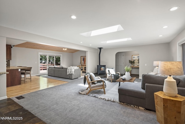 1705 Blue Spruce Rd, Reno, NV 89511 - living area with a wood stove, a skylight, arched walkways, and recessed lighting