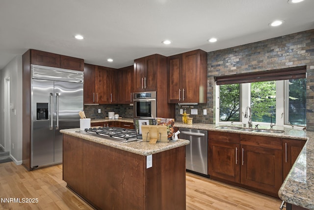 1705 Blue Spruce Rd, Reno, NV 89511 - kitchen with appliances with stainless steel finishes, light wood-type flooring, light stone counters, tasteful backsplash, and recessed lighting