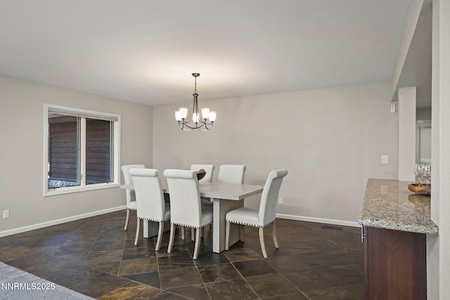 1705 Blue Spruce Rd, Reno, NV 89511 - dining space with dark stone finish floors and a chandelier
