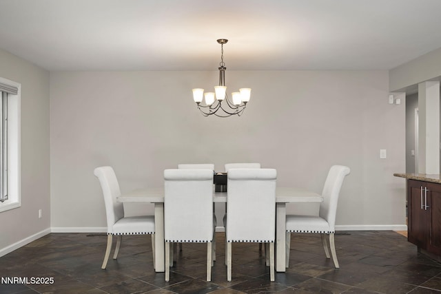 1705 Blue Spruce Rd, Reno, NV 89511 - dining area featuring a chandelier and dark stone finish flooring