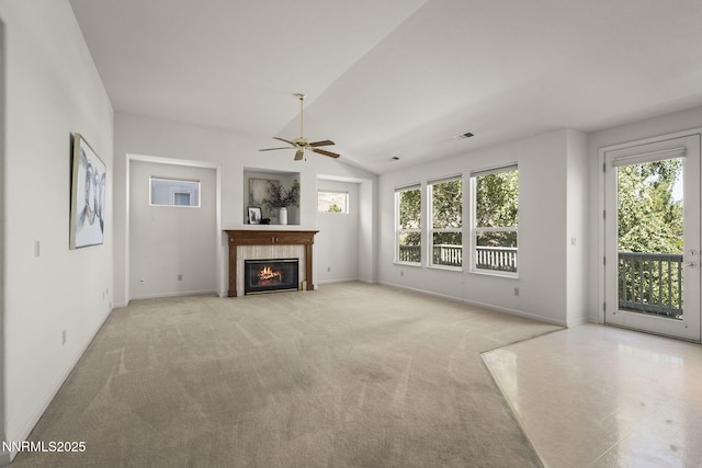 4811 Elkcreek Trl, Reno, NV 89519 - unfurnished living room featuring ceiling fan, a tiled fireplace, lofted ceiling, and light colored carpet